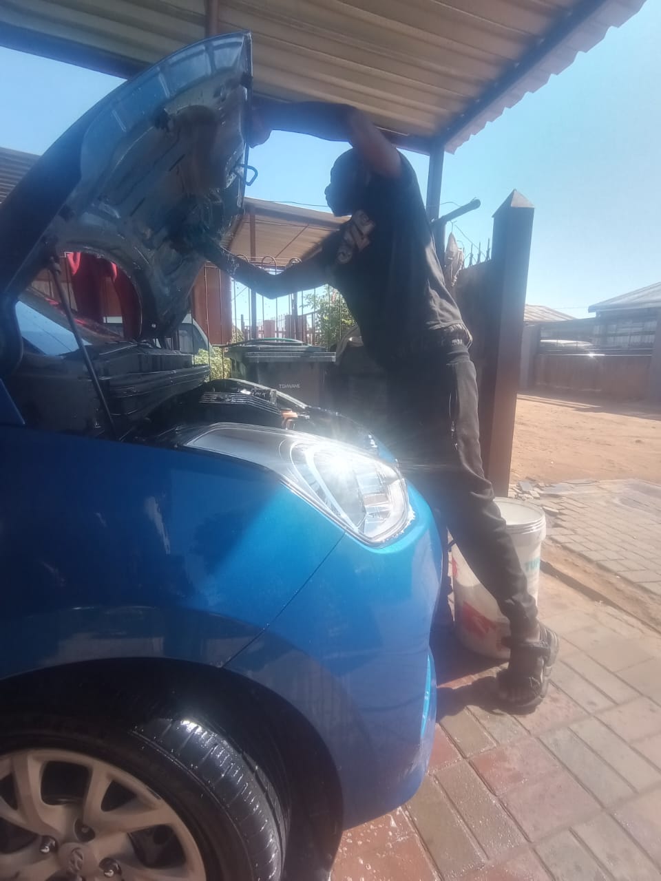 Thapelo working under the hood — engine inspection and servicing